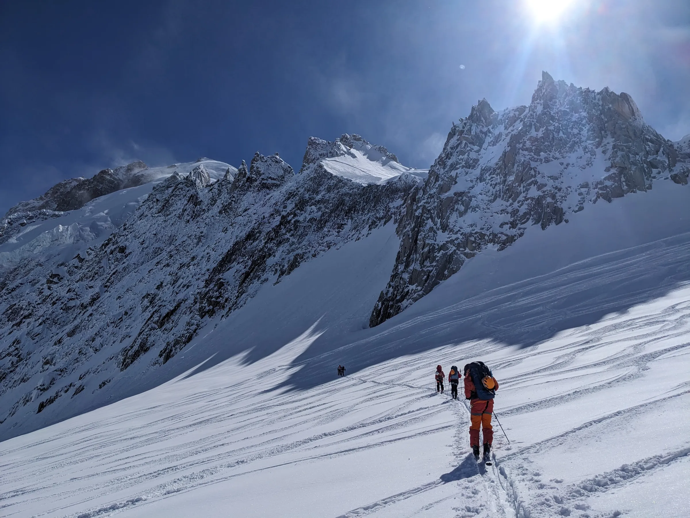 Jan traversing a snowy mountain slope while cross-country snowboarding in the Alps between Chamonix and Zermatt