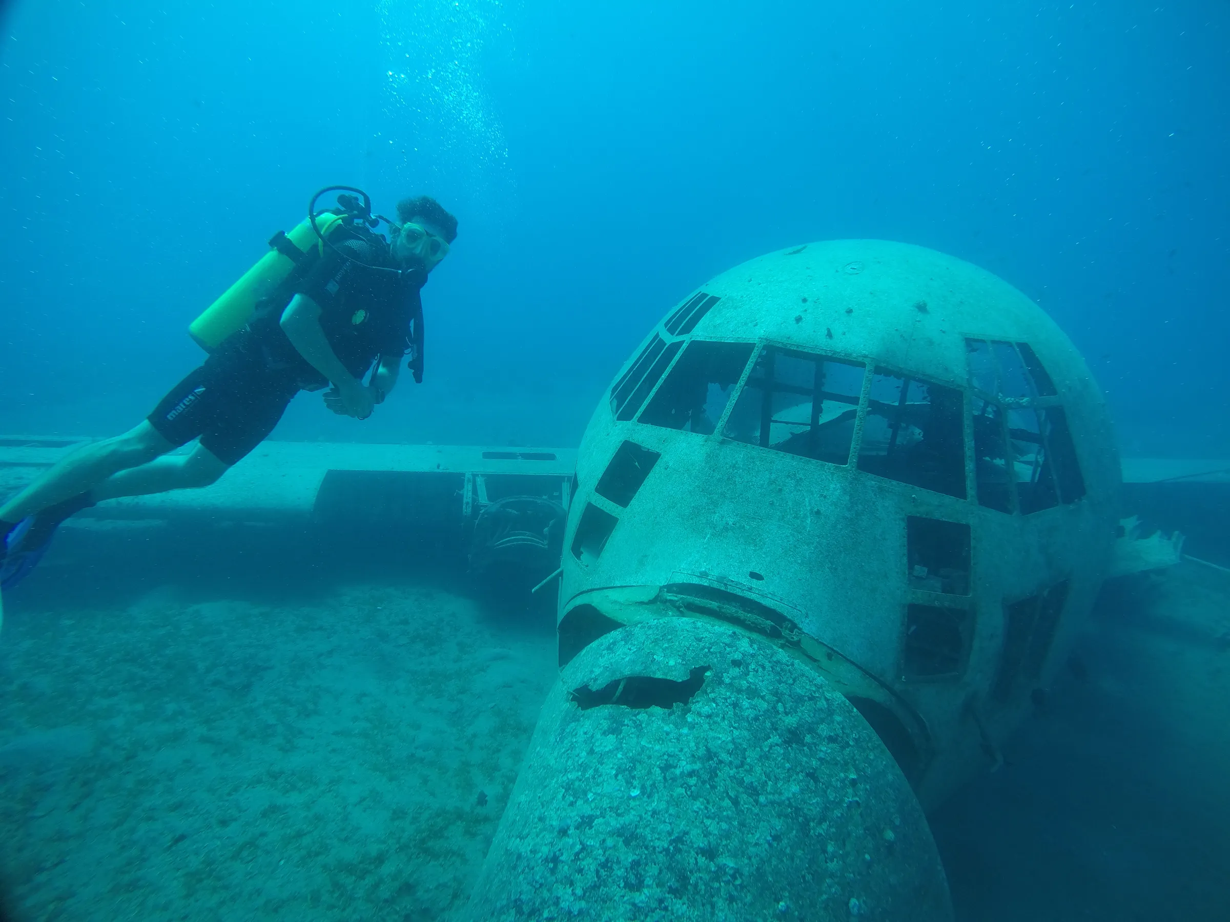 Jan scuba diving near a sunken aircraft