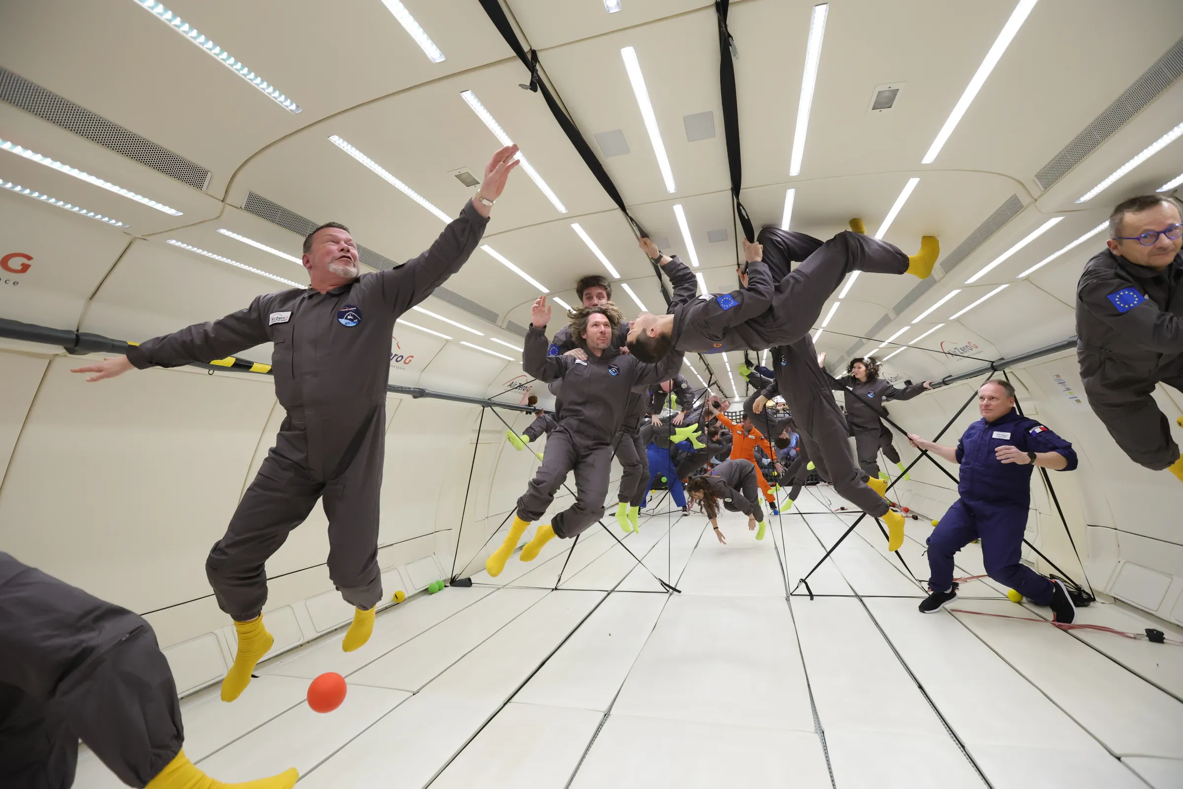 Jan climbing along the ceiling during a Zero-G flight